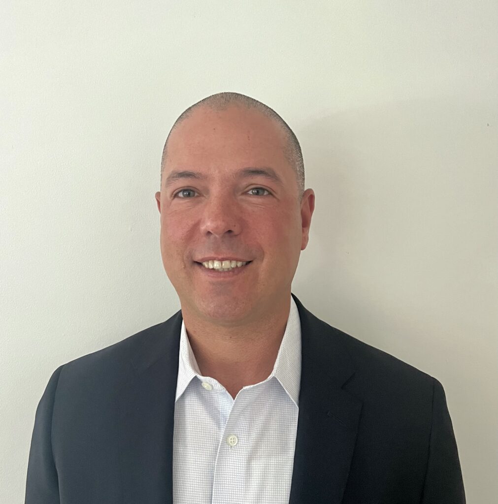 Headshot photo of Dr. Michael Massa, Education Subject Matter Expert for the Office of Youth and Community Restoration (OYCR). Dr. Massa is wearing a dark suit jacket over a white button-down dress shirt.