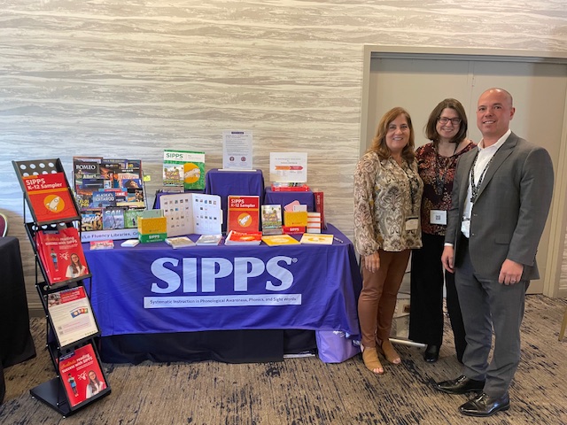Stacy Storm, Dr. Jennifer McMahon, and OYCR's Dr. Michael Massa in front of Collaborative Classroom's SIPPS booth featuring SIPPS literacy resources at the Juvenile Court, Community and Alternative School Administrators of California (JCCASAC) conference
