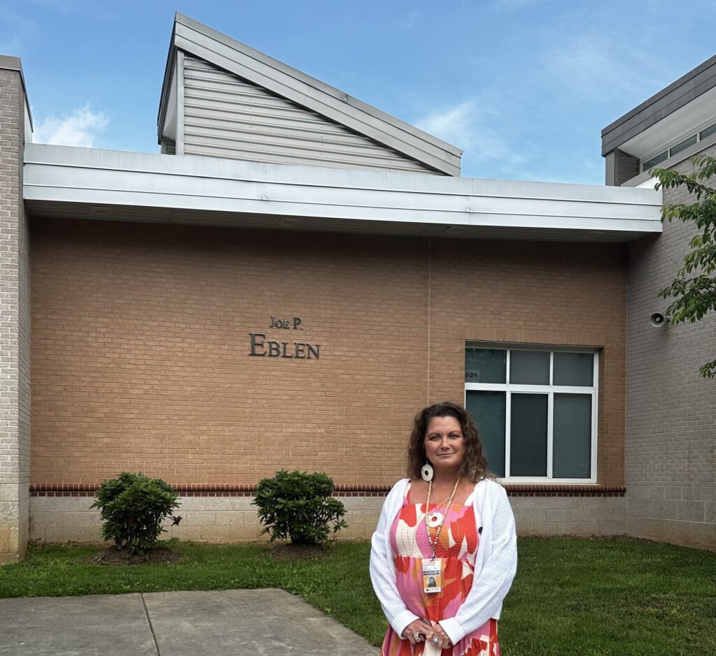 Photo shows Title 1 Reading Specialist Pamela Hunter standing in front of Joe P. Eblen Intermediate School in Buncombe County, NC. where she uses SIPPS to meet the needs of her older readers.