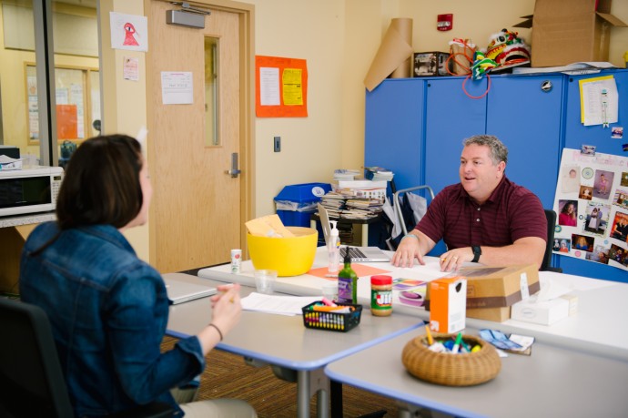 teachers having a discussion in the break room