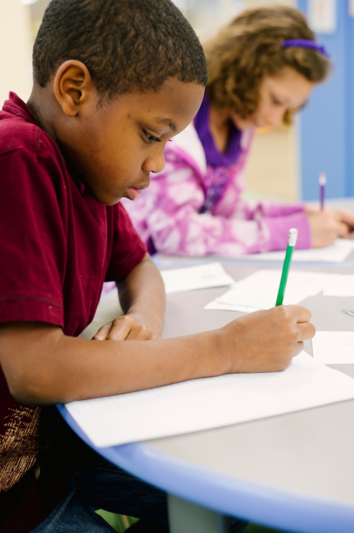 students writing at a table