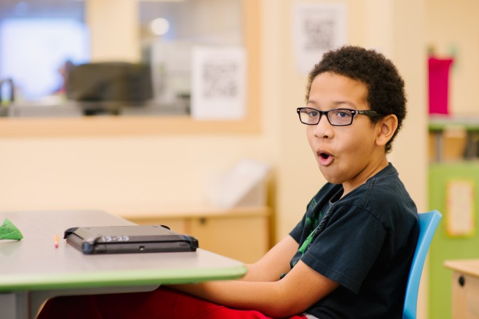 student with tablet computer at desk