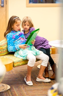 two girls reading together